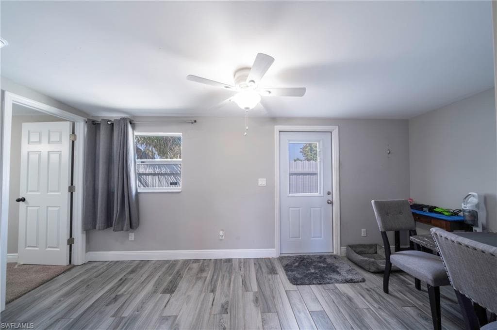 Entrance foyer with a ceiling fan and light wood-style floors