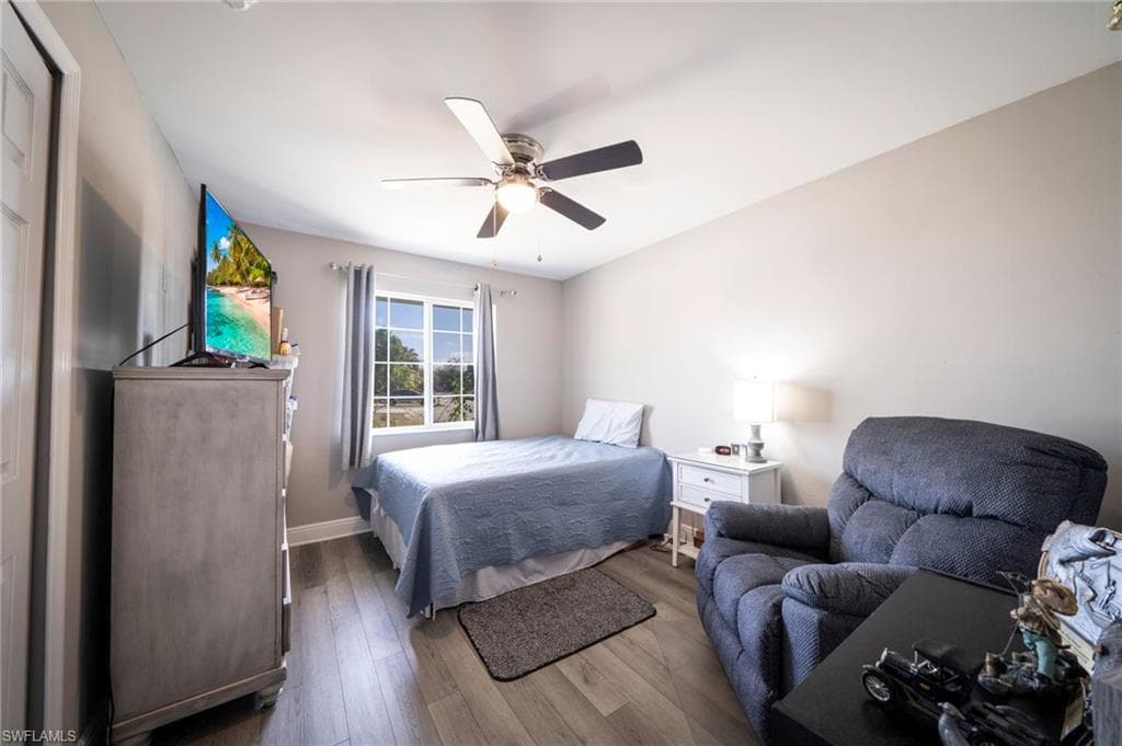 Bedroom featuring dark wood-style floors and ceiling fan