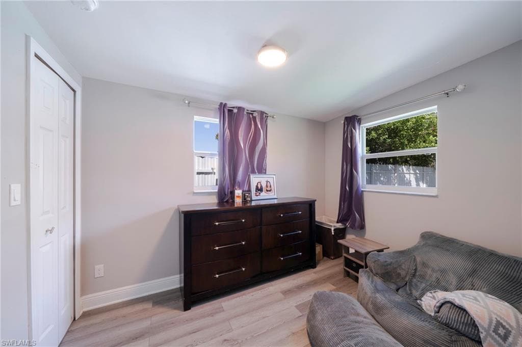 Sitting room with light wood-type flooring and baseboards