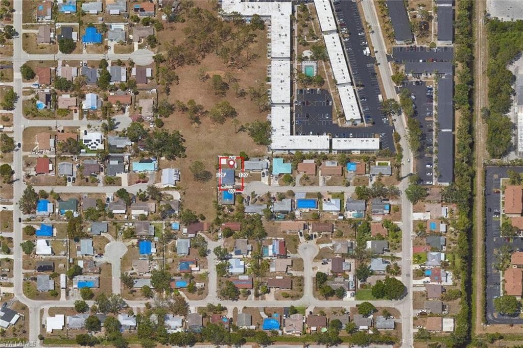 Aerial view of property's location featuring nearby suburban area