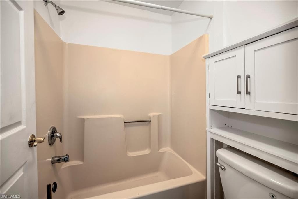 Full bathroom with shower / bath combination and toilet
