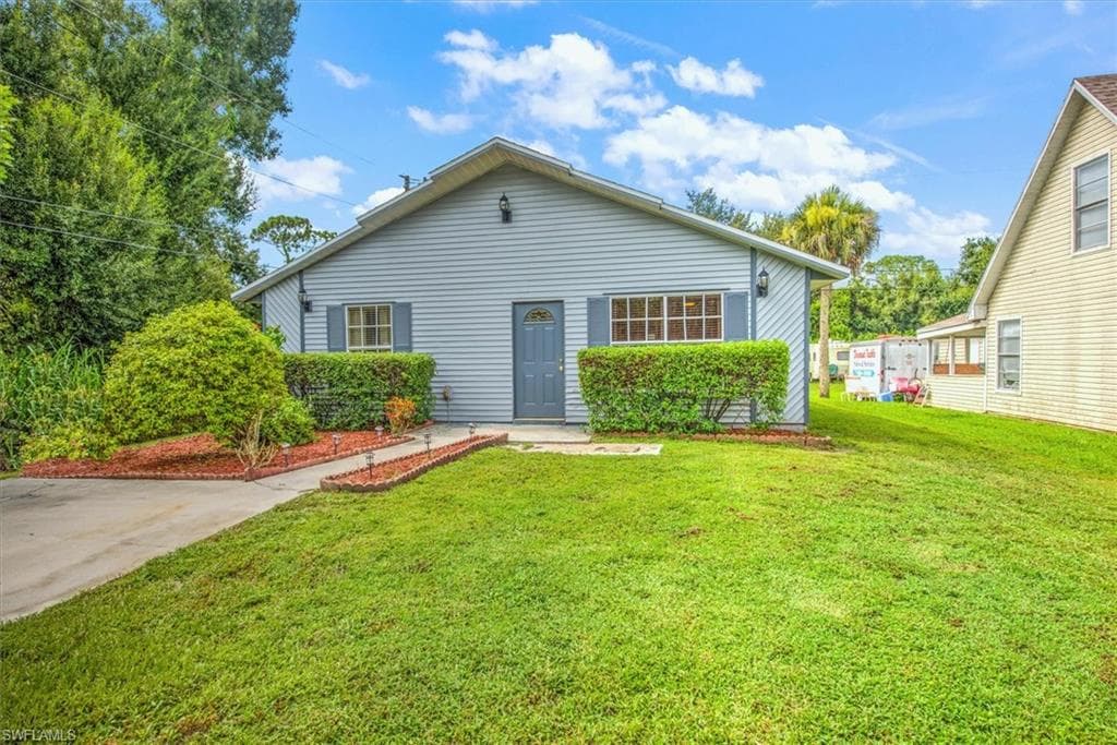 Rear view of property featuring a lawn
