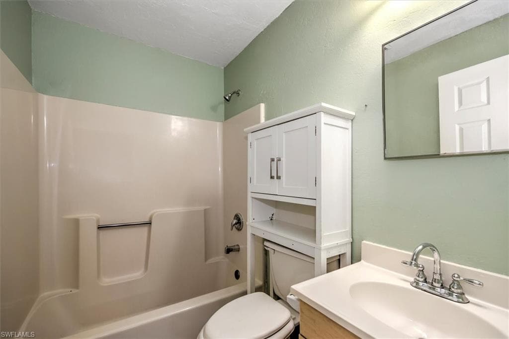 Full bathroom featuring tub / shower combination and vanity