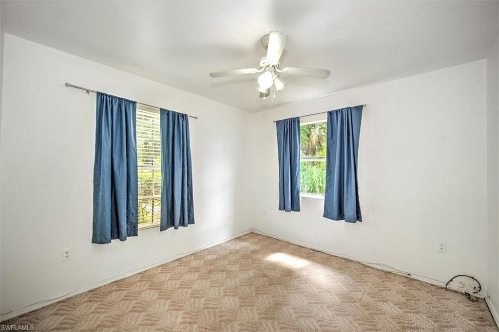 Unfurnished room with ceiling fan and parquet flooring