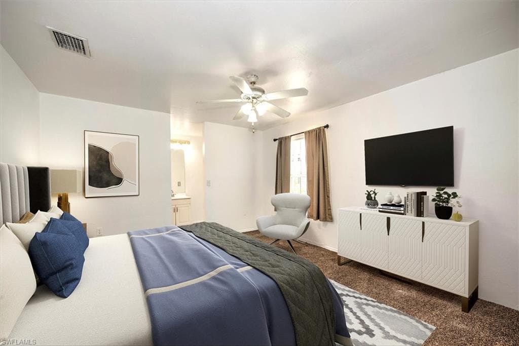 Carpeted bedroom featuring a ceiling fan and connected bathroom