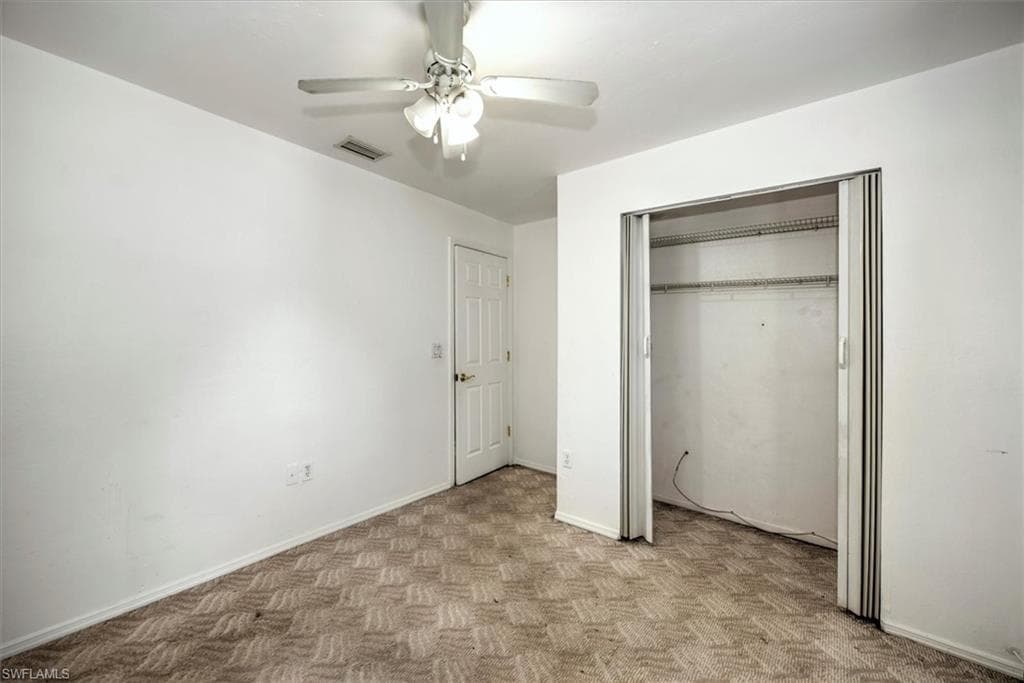 Unfurnished bedroom with a closet and ceiling fan