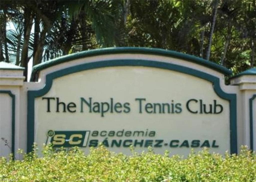Community / neighborhood sign featuring an attached garage