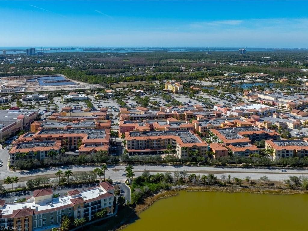 Aerial view of property and surrounding area featuring a large body of water