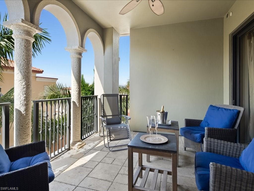 Balcony with an outdoor living space with a fire pit and ceiling fan