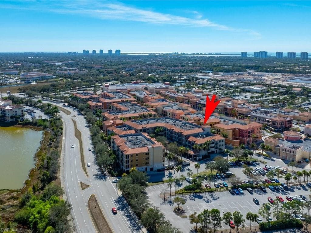 Aerial overview of property's location featuring city skyline and a large body of water