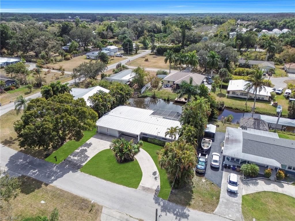 Aerial perspective of suburban area featuring a nearby body of water