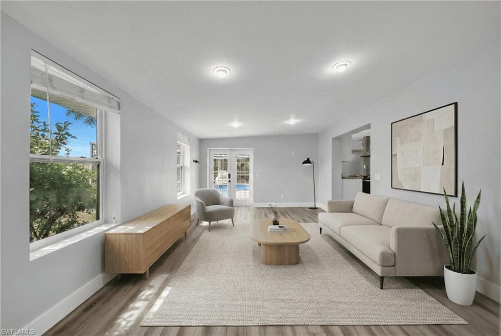 Living room with french doors and wood finished floors