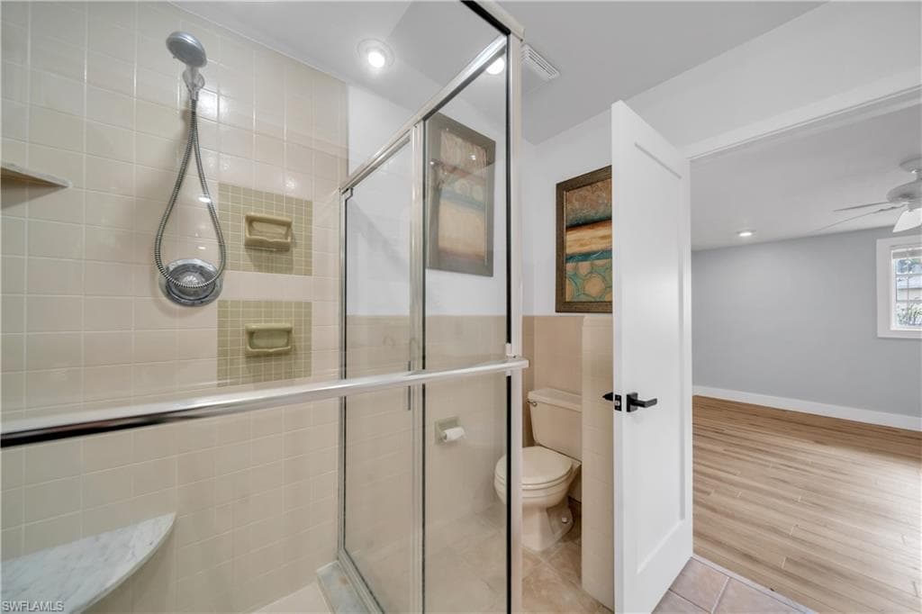 Bathroom with a stall shower, recessed lighting, tile patterned floors, and ceiling fan