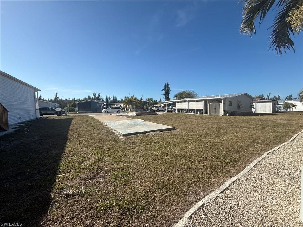 View of green lawn featuring a residential view