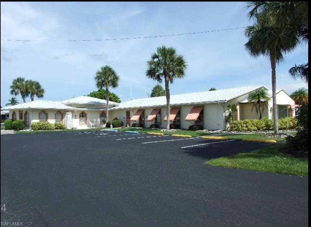 Community building exterior with uncovered parking
