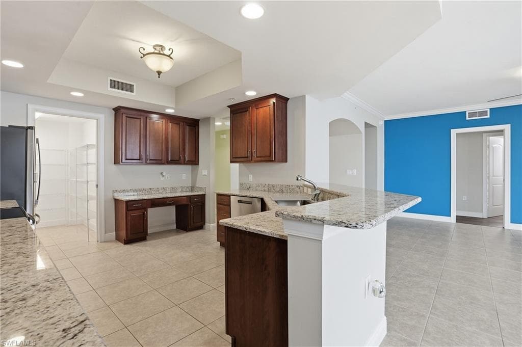 Kitchen featuring a peninsula, granite countertops, light tile flooring, stainless steel appliances, and recessed lighting