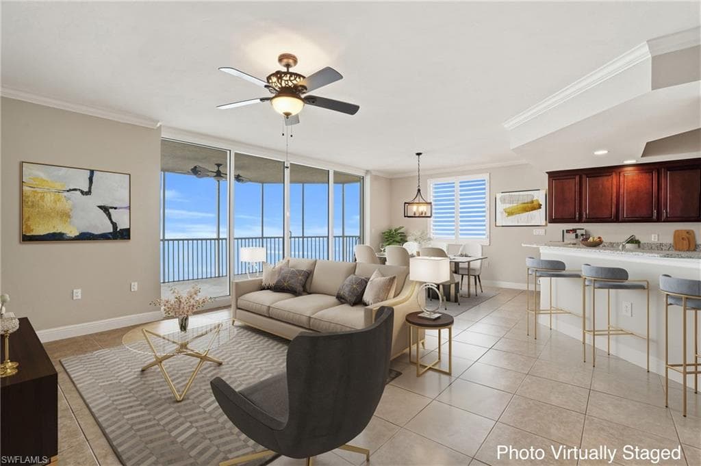 Virtually Stagged Living/Dining area room featuring floor to ceiling windows, ornamental molding, ceiling fan, and light tile floors