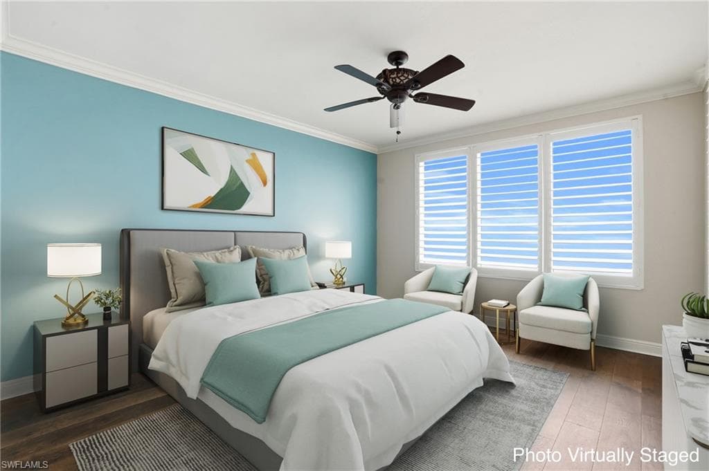 Virtually Staged Primary ensuite with ceiling fan, hard wood finished floors, and crown molding