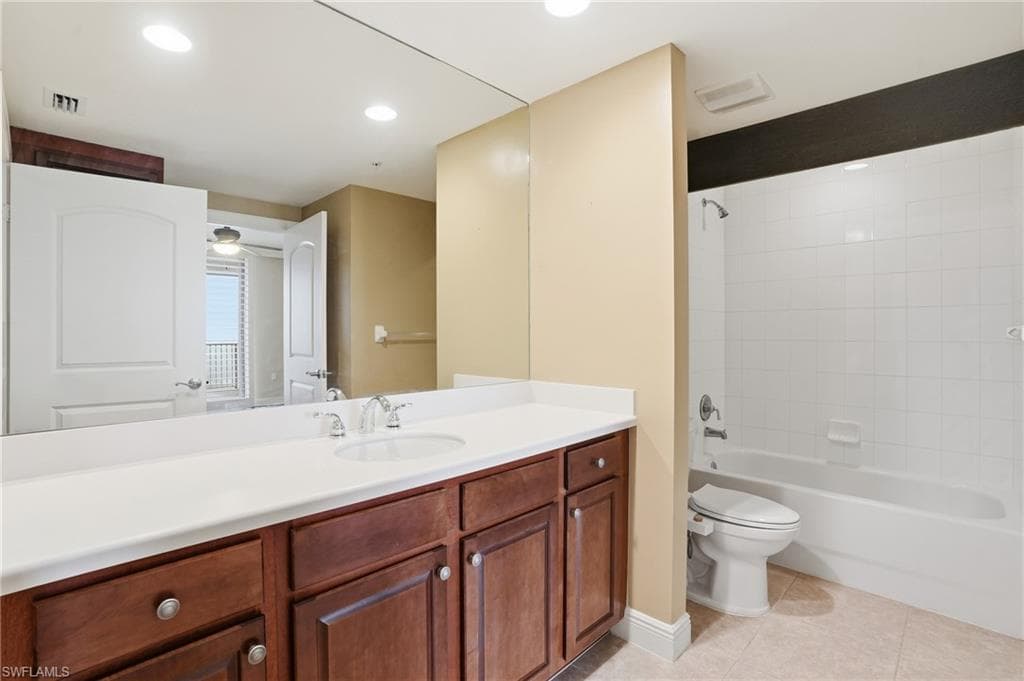 Guest Bathroom featuring vanity, shower / washtub combination, light tile patterned floors, and recessed lighting