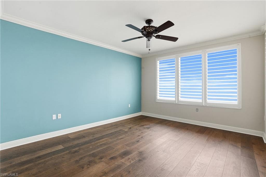 Primary ensuite with ceiling fan, hard wood finished floors, and crown molding