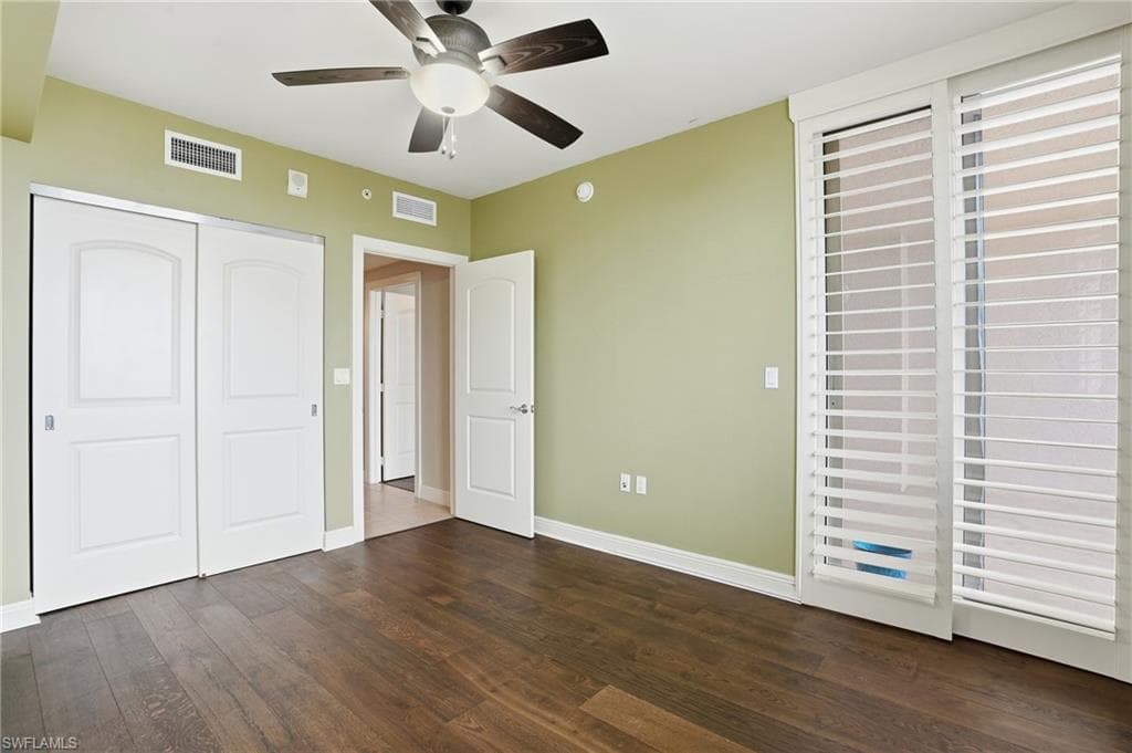 2nd bedroom featuring hard wood flooring, ceiling fan, and a closet