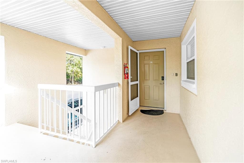 Doorway to property featuring stucco siding