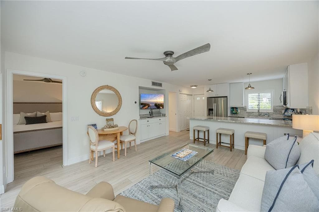 Open-concept living area featuring wood-finish flooring