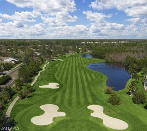 Drone / aerial view of a nearby body of water and a golf club