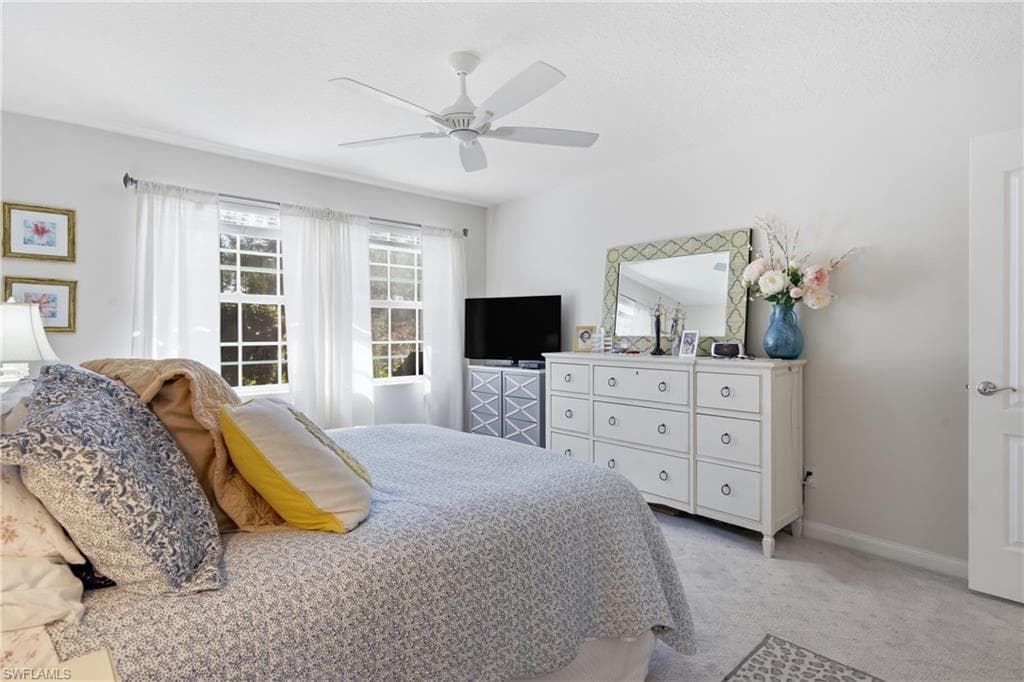 Spacious primary suite with vaulted ceiling and peaceful views.