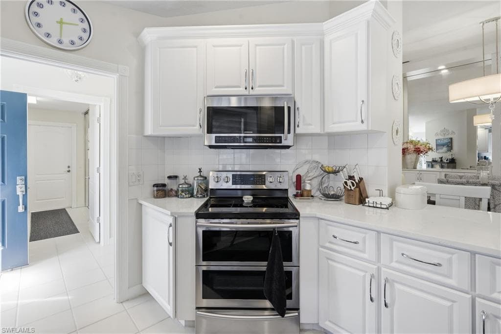 Kitchen with quartz counters, ample prep space, and open view to living area.