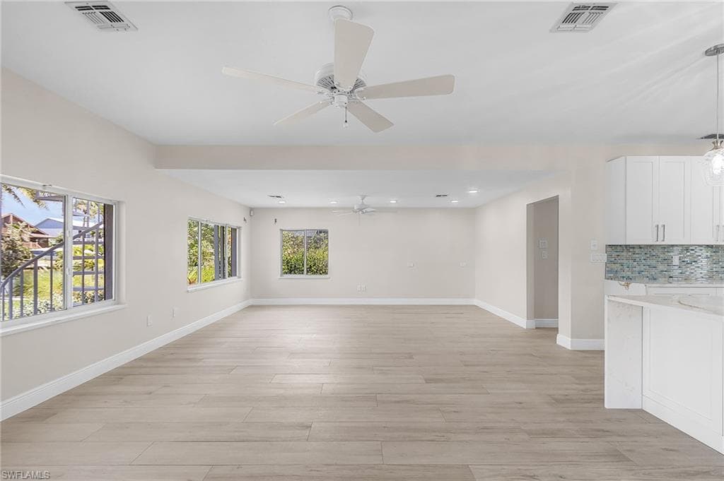 Family room featuring light wood-type flooring, plenty of natural light, ceiling fan, and recessed lighting