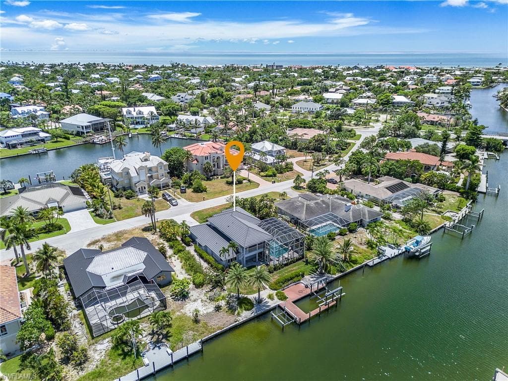 Aerial view of residential area featuring a nearby body of water