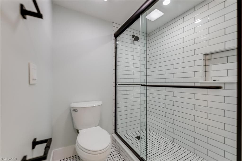 Full bathroom with a shower stall