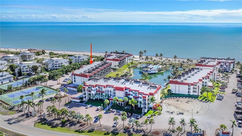 Bird's eye view of apartment complex and a nearby body of water