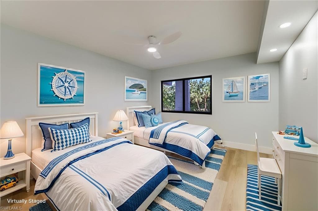 Bedroom with light wood finished floors, ceiling fan, and recessed lighting