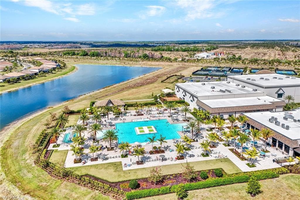 Bird's eye view of a pool and a nearby body of water
