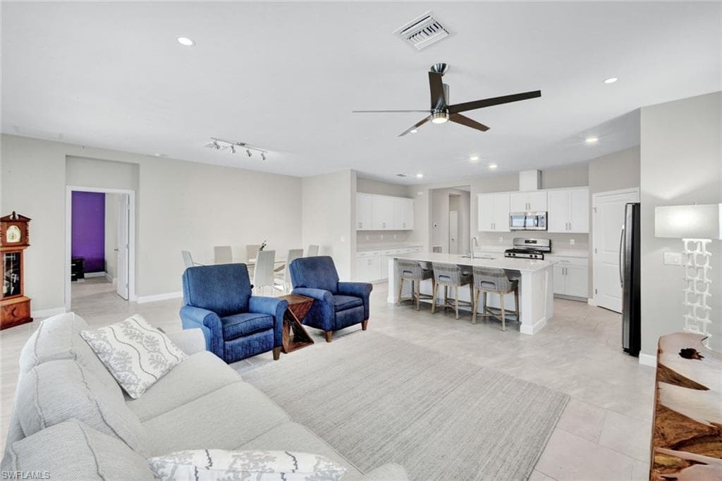 Living area with a ceiling fan and recessed lighting