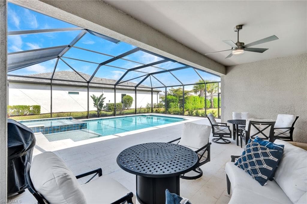 Integrated pool / hot tub with a patio area, a sunroom, a lanai, and area for grilling