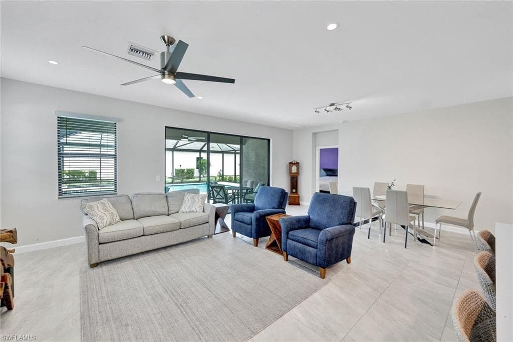 Living area featuring a sunroom, ceiling fan, and recessed lighting