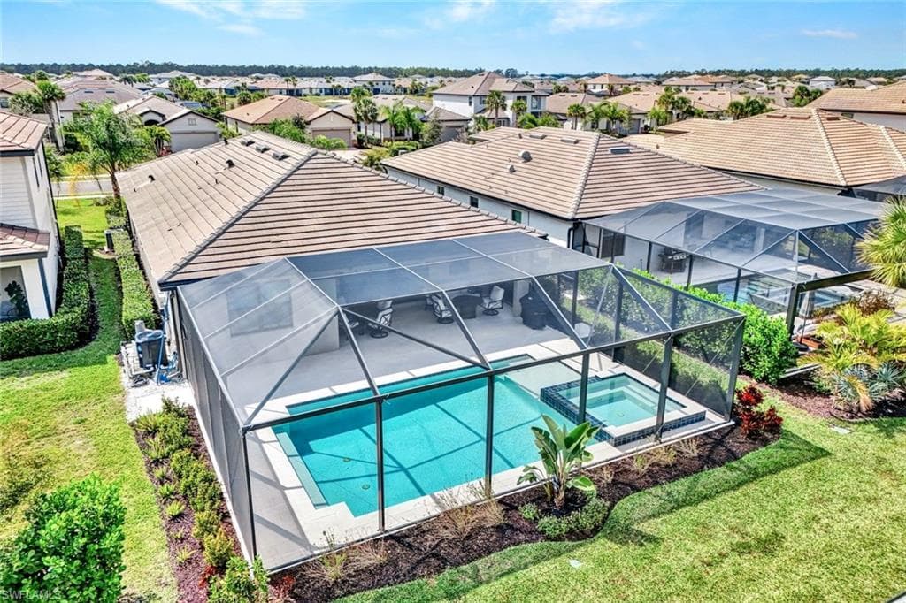 Aerial perspective of suburban area featuring a pool area