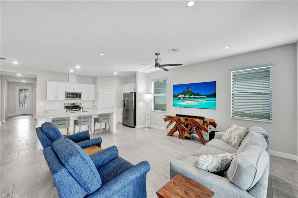 Living room featuring recessed lighting and ceiling fan