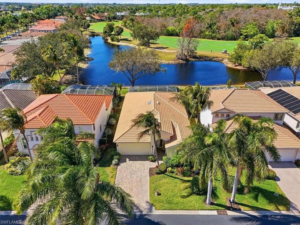 Aerial perspective of suburban area with a large body of water and a local golf course