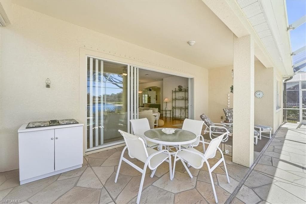 View of patio / terrace with outdoor dining space, a sunroom, and a lanai