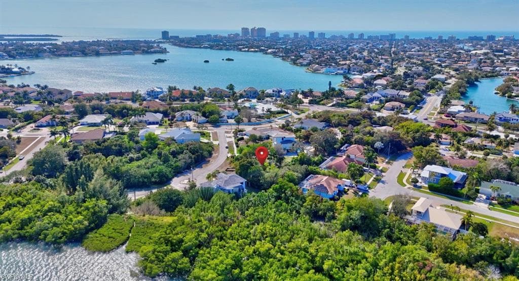 Aerial view of residential area featuring a large body of water