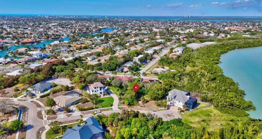 Aerial view of residential area featuring a large body of water