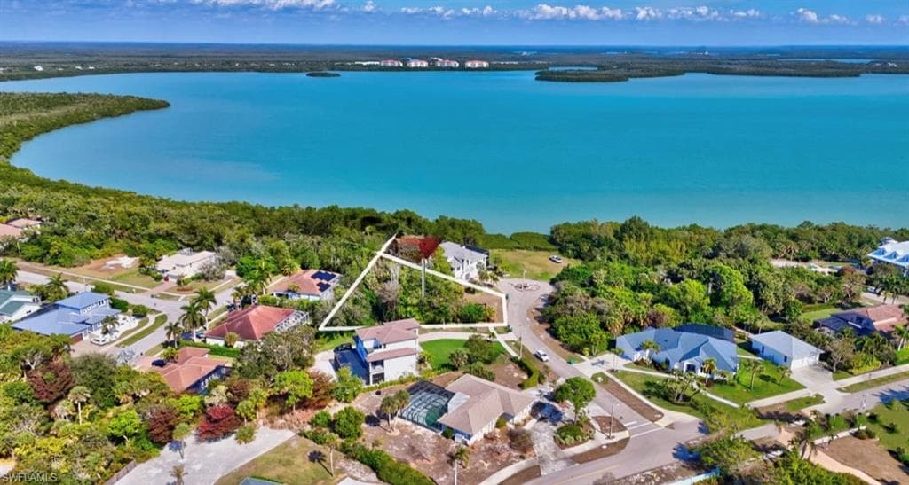 Aerial view of residential area featuring a large body of water