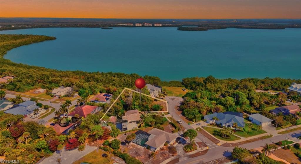 Aerial view of residential area featuring a large body of water