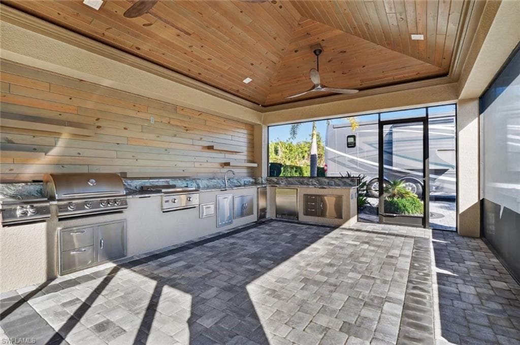View of patio / terrace with area for grilling and a ceiling fan