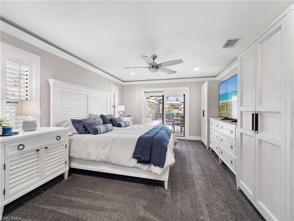 Bedroom featuring dark colored carpet, a ceiling fan, ornamental molding, access to exterior, and recessed lighting