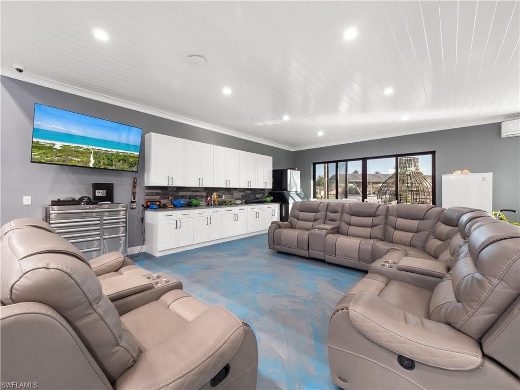 Living area featuring recessed lighting, light colored carpet, and crown molding